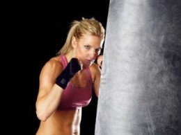 female hitting heavy bag